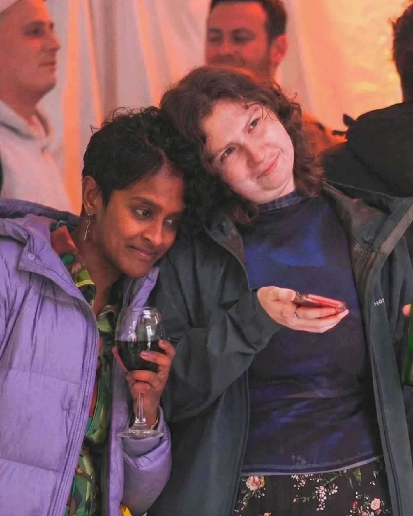Two friends leaning in together at a Doddz show