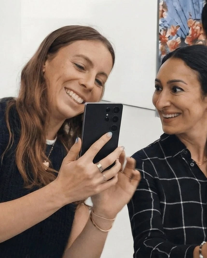 Two friends delighted by the augmented reality layer on their phones