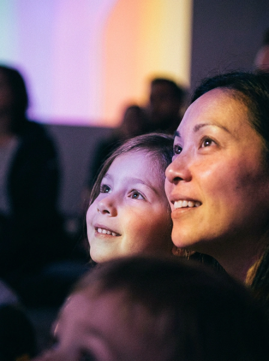 A mother and daughter looking up in wonder at a Doddz show
